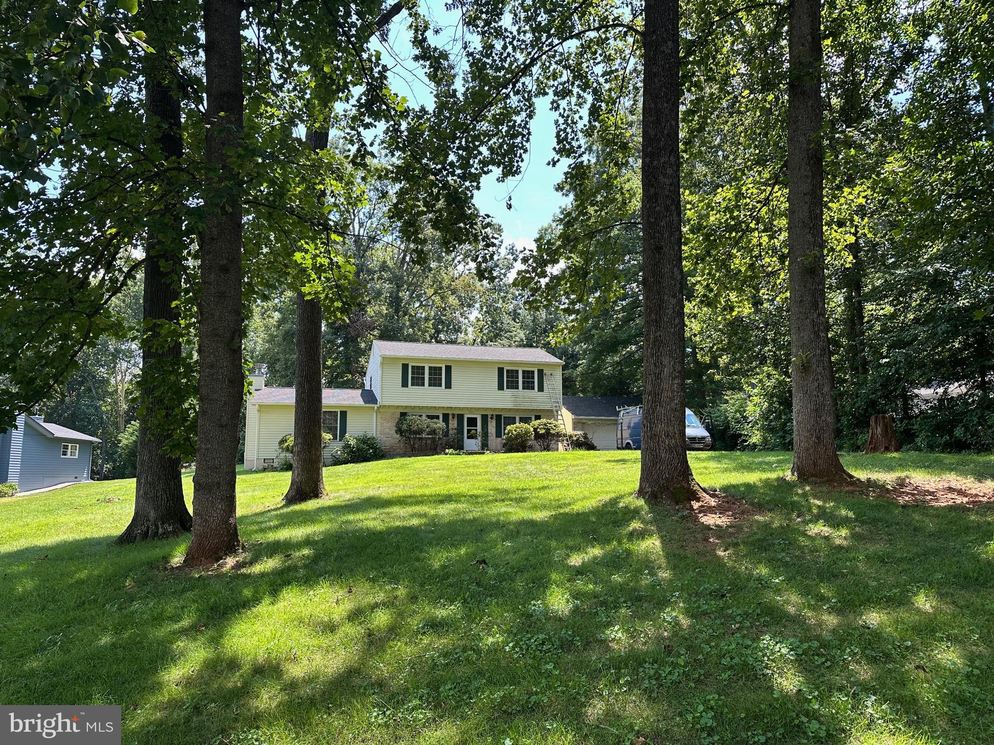 Charming home nestled among lush trees.