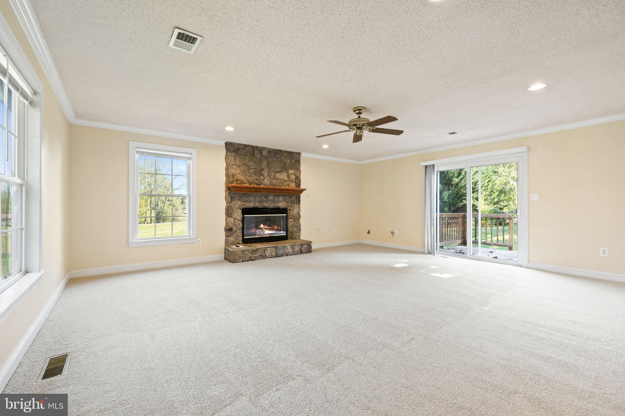 Spacious living area with cozy fireplace.