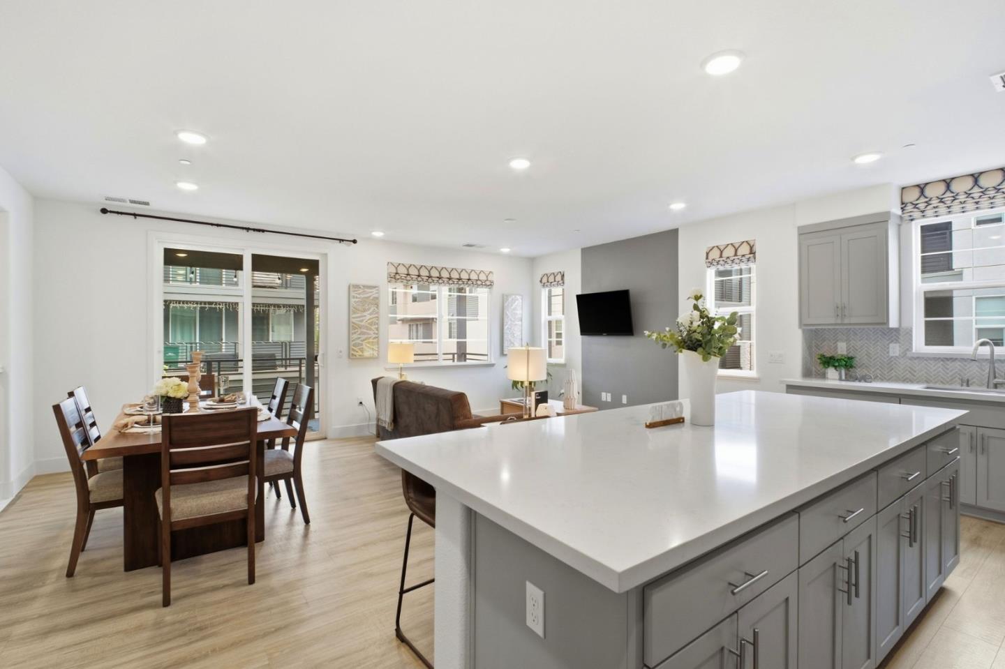 385 Line Street Hayward, CA 94544 - Photo 11 of 38 a kitchen with a table chairs and wooden floor