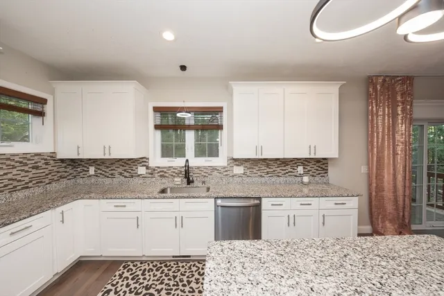 a kitchen with a sink stove and cabinets