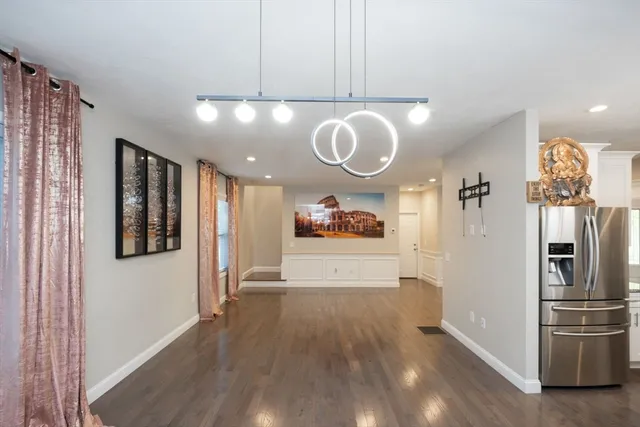a view of a kitchen with a refrigerator and a microwave