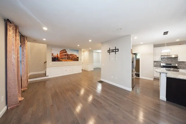 a view of a kitchen with a sink and a refrigerator