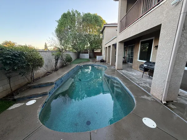 a view of a swimming pool with a yard