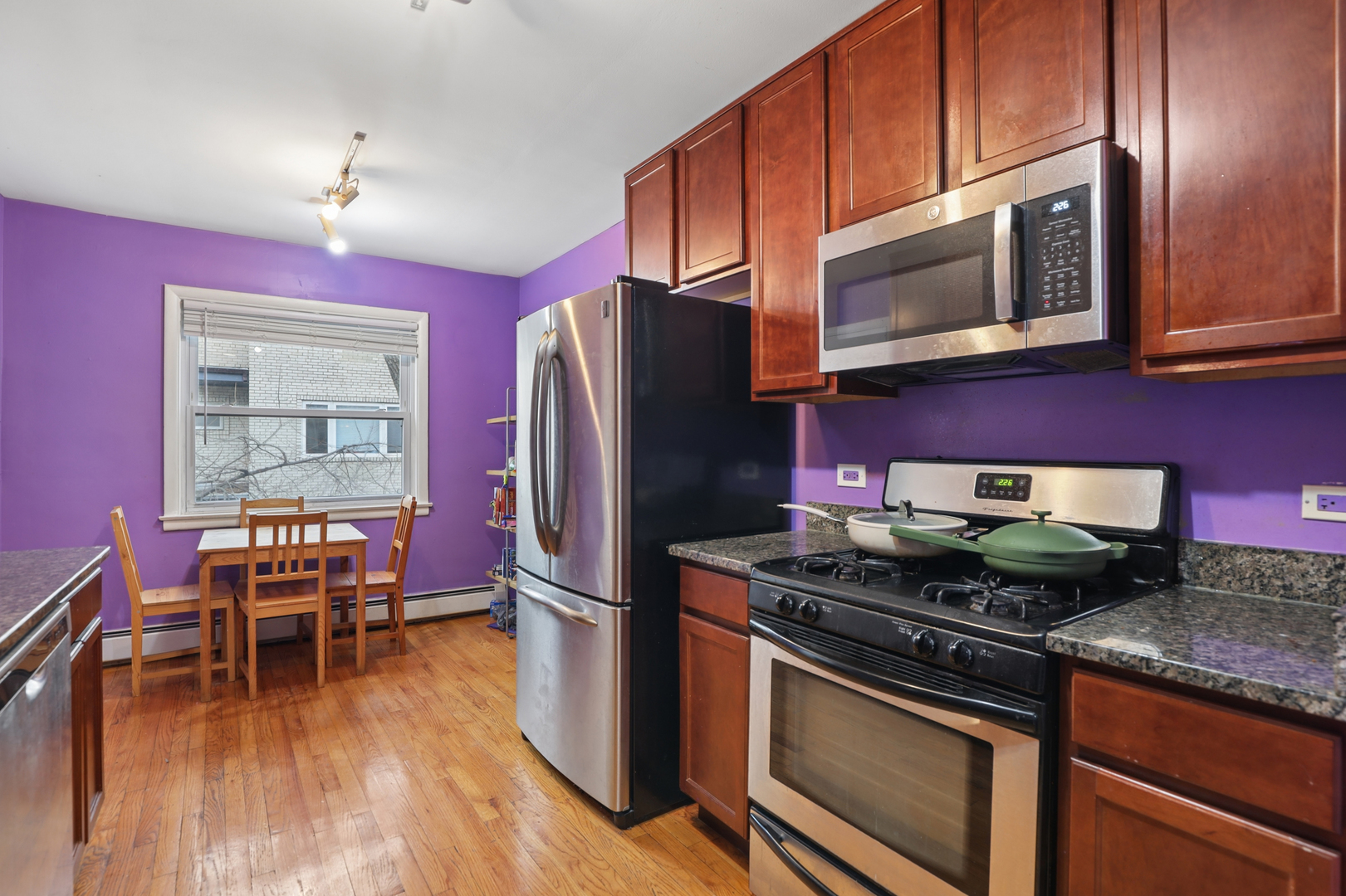2147 Ridge Avenue, Unit 2D Evanston, IL 60201 - Photo 9 of 22 a kitchen with stainless steel appliances granite countertop a stove refrigerator and microwave