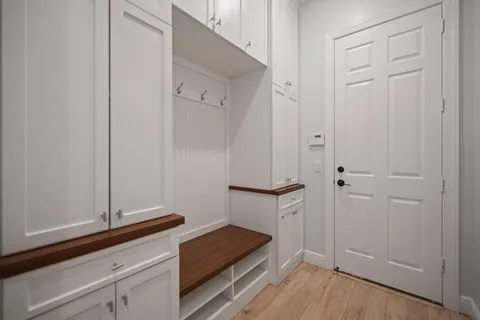 a view of an empty room with a fireplace and a window