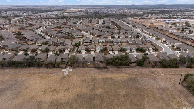 an aerial view of a house with a yard