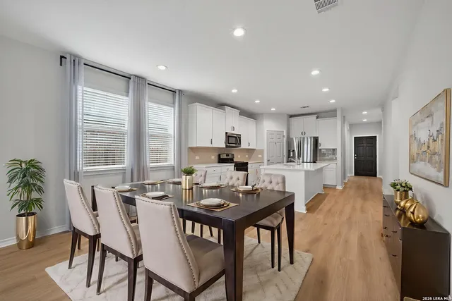 a view of a dining room with furniture and windows