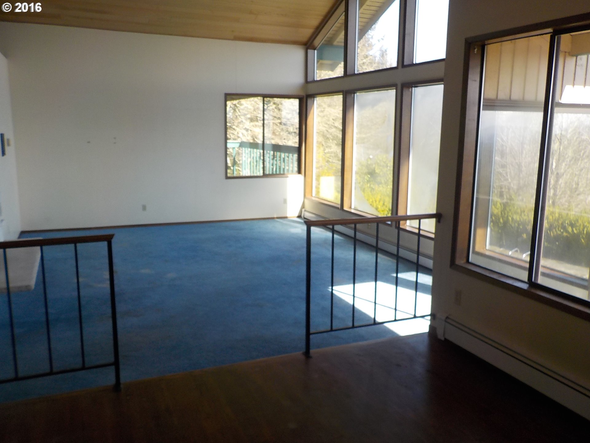 13110 Southwest Whitmore Road Hillsboro, OR 97123 - Photo 6 of 10 a view of an empty room with wooden floor and a window