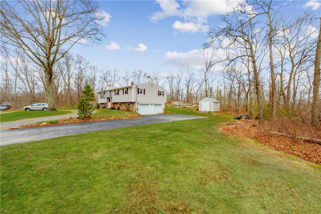 46 Indian Hill Road Tiverton, RI 02878 - Photo 2 of 21 Another street view showing garage underneath and outdoor shed.