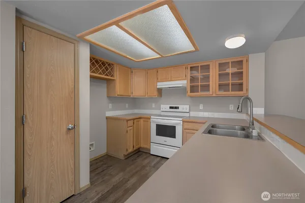 a kitchen with a sink cabinets and appliances