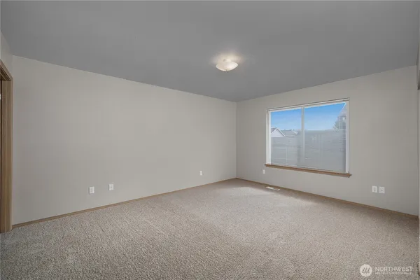 a view of an empty room and a window