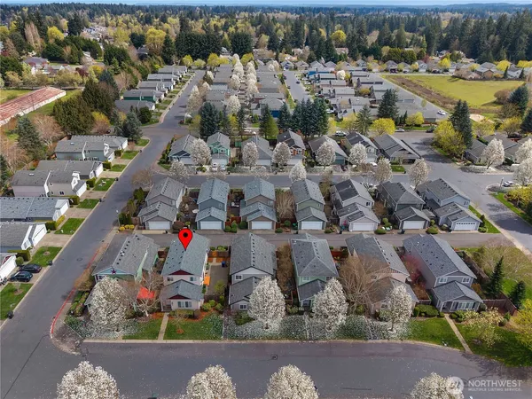 an aerial view of multiple houses with a yard