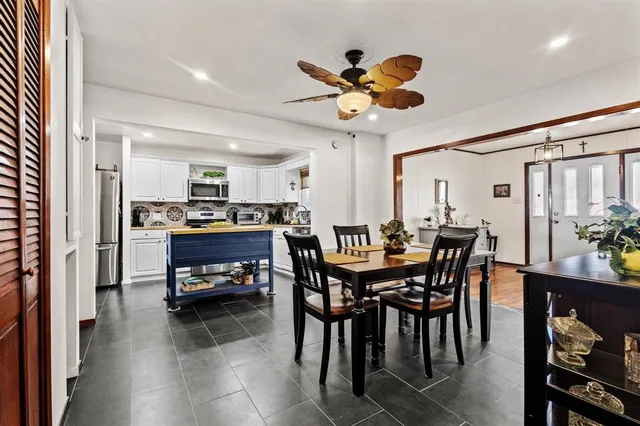 a view of a dining room with furniture and a potted plant