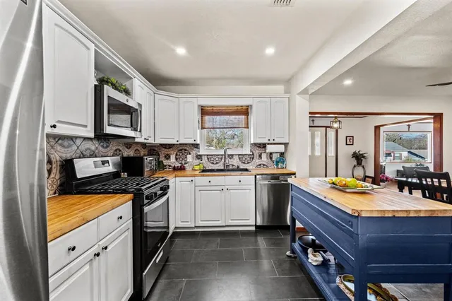 a kitchen with sink stove and microwave