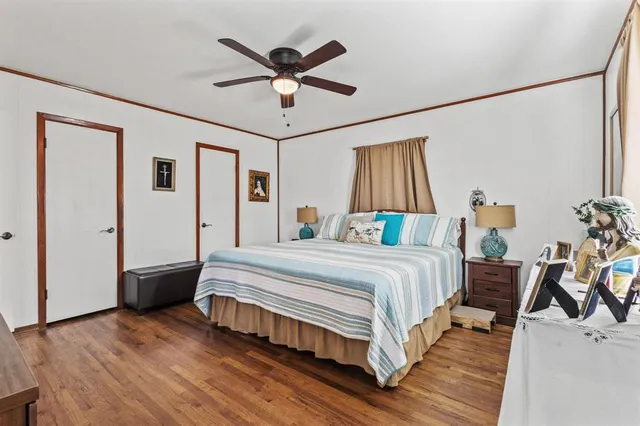 a spacious bedroom with a bed and a chandelier