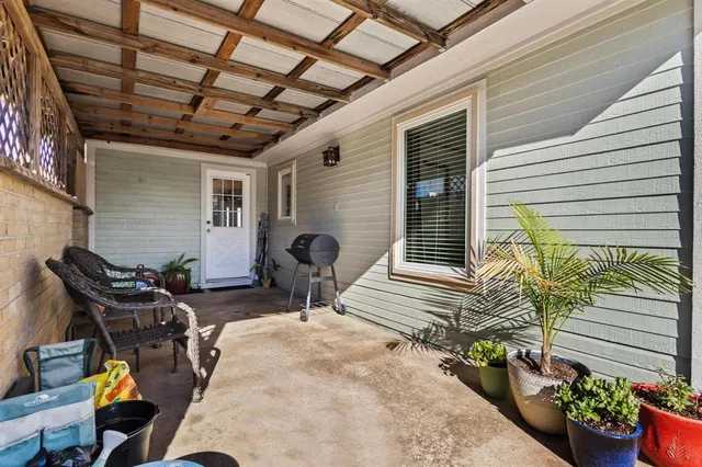 a view of a backyard with furniture and a garden