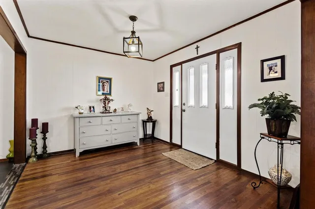 a view of a workspace with wooden floor and furniture