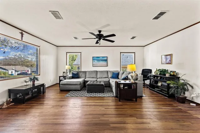 a living room with furniture and wooden floor