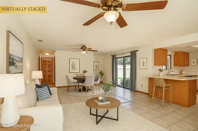 a living room with furniture a ceiling fan and a rug