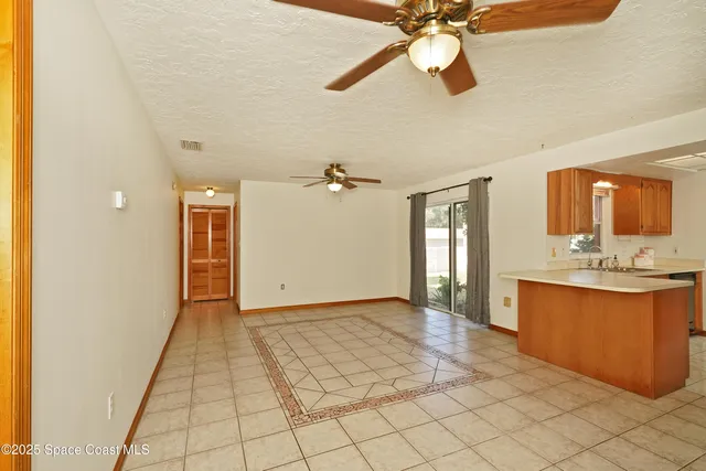 a view of an entryway with a chandelier fan