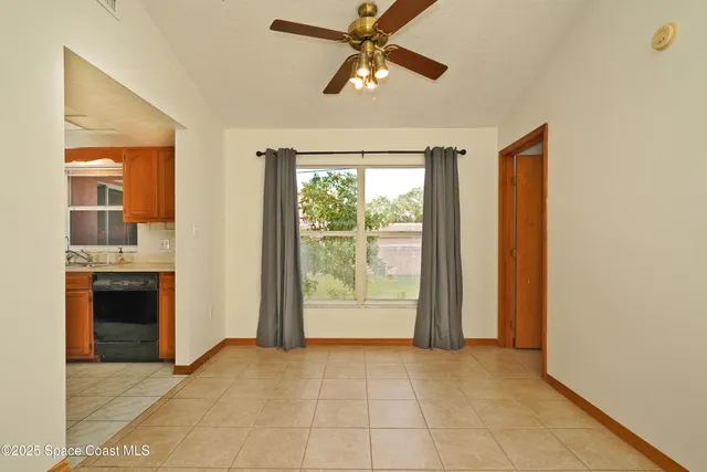 a view of an empty room with a fireplace and a window
