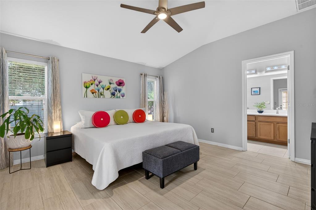 12629 White Bluff Road Hudson, FL 34669 - Photo 11 of 38 a bedroom with a bed and a chandelier