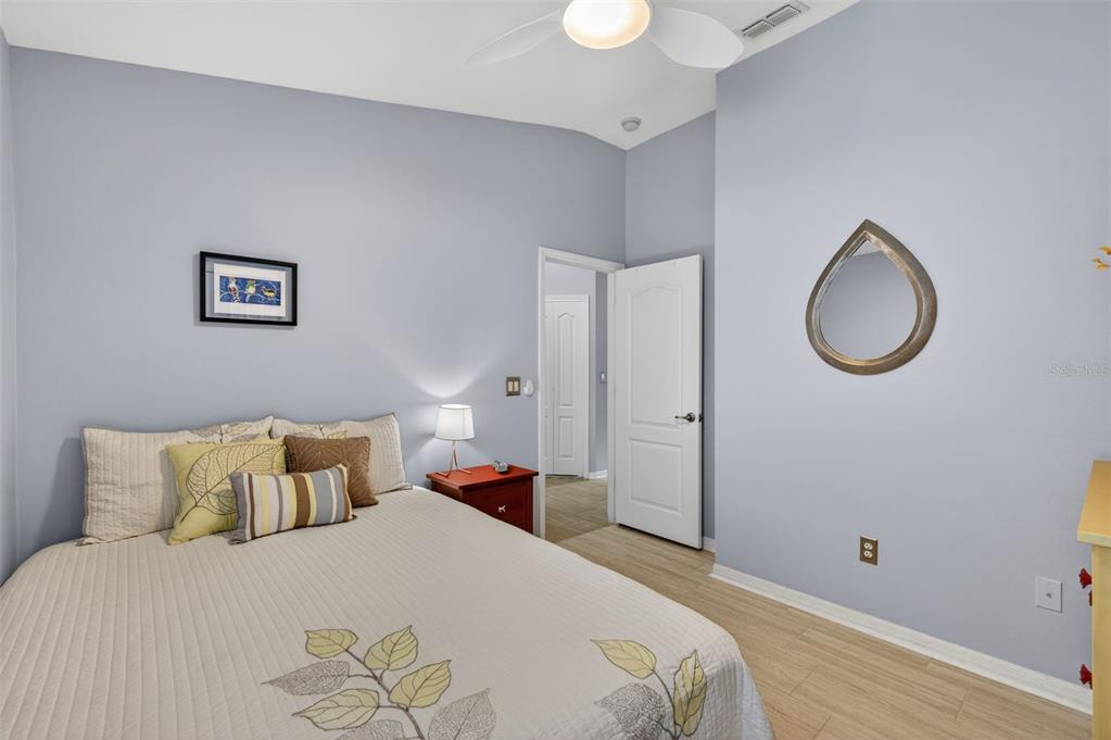 12629 White Bluff Road Hudson, FL 34669 - Photo 20 of 38 a bedroom with a bed and a chandelier