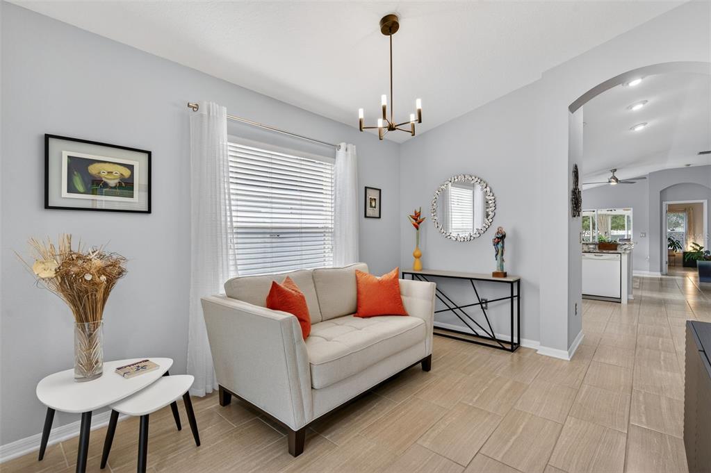 12629 White Bluff Road Hudson, FL 34669 - Photo 4 of 38 a living room with furniture a rug and a chandelier