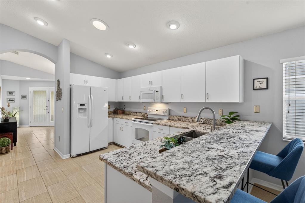 12629 White Bluff Road Hudson, FL 34669 - Photo 5 of 38 a kitchen with stainless steel appliances granite countertop a refrigerator and sink