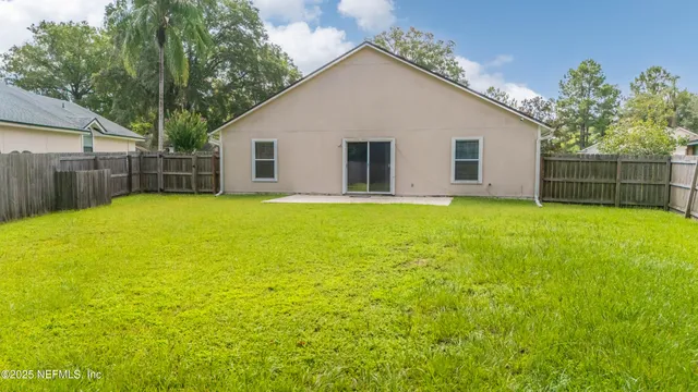 a view of a house with a yard and garage