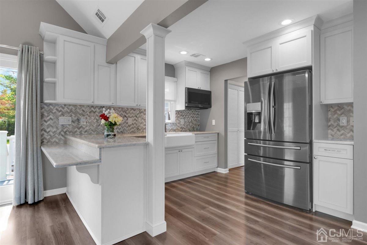 23 Southfield Road Edison, NJ 08820 - Photo 27 of 57 a kitchen with stainless steel appliances a refrigerator sink and wooden floor