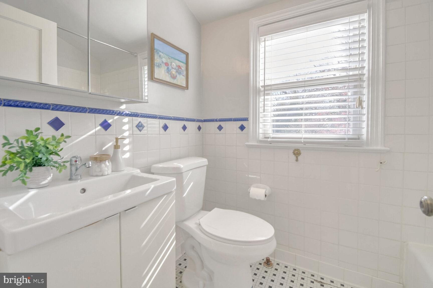 112 St Lawrence Drive Silver Spring, MD 20901 - Photo 13 of 30 a bathroom with a sink a toilet and a window