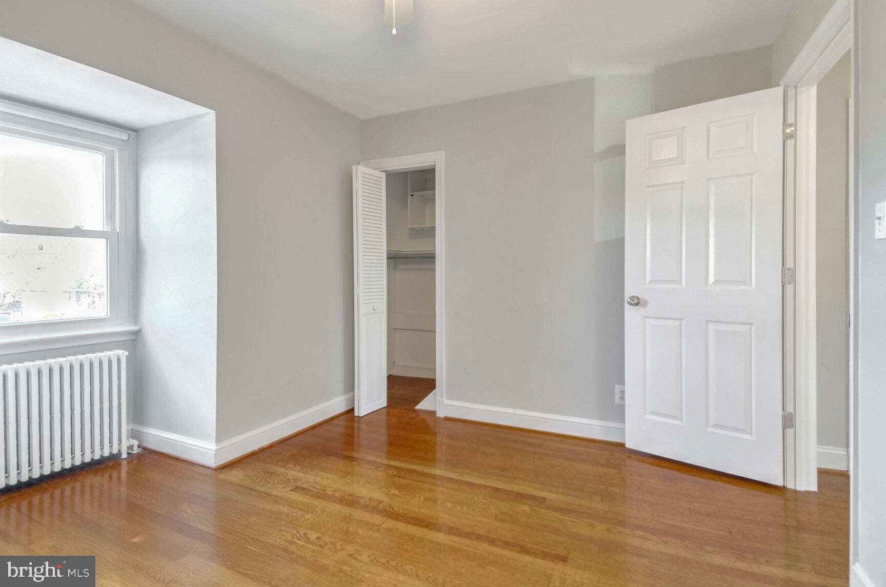 112 St Lawrence Drive Silver Spring, MD 20901 - Photo 16 of 30 a view of an empty room with wooden floor and a window
