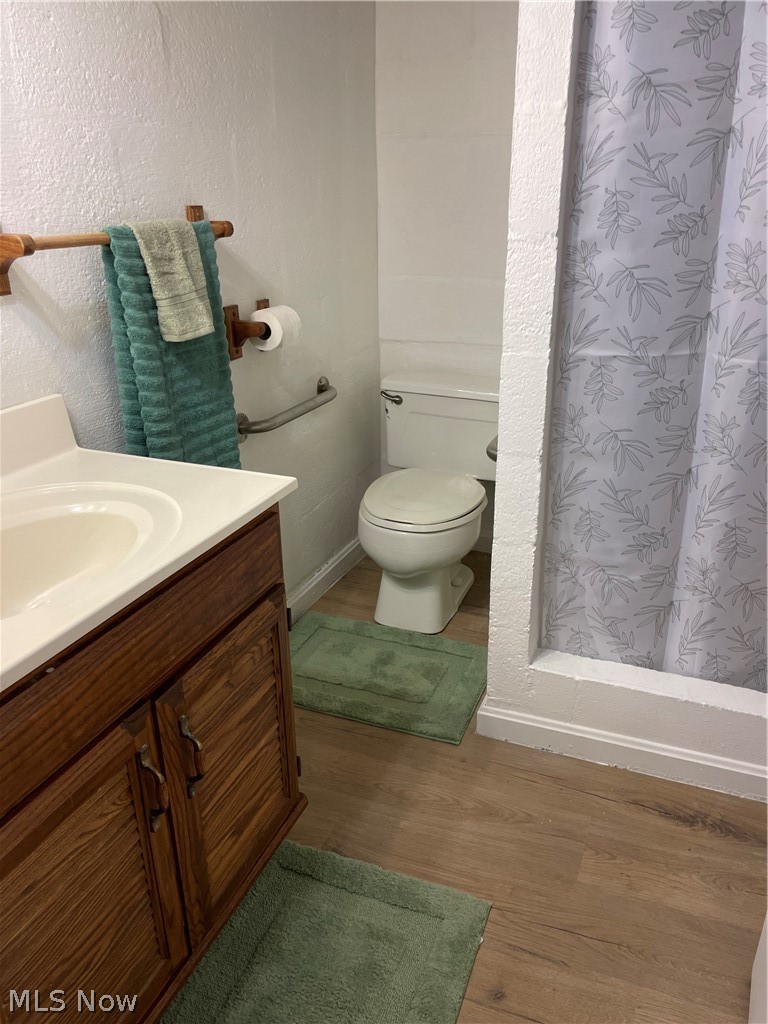 3025 Killian Road Uniontown, OH 44685 - Photo 11 of 23 Bathroom featuring vanity, a textured wall, a shower stall, and 30 year waterproof LTV flooring