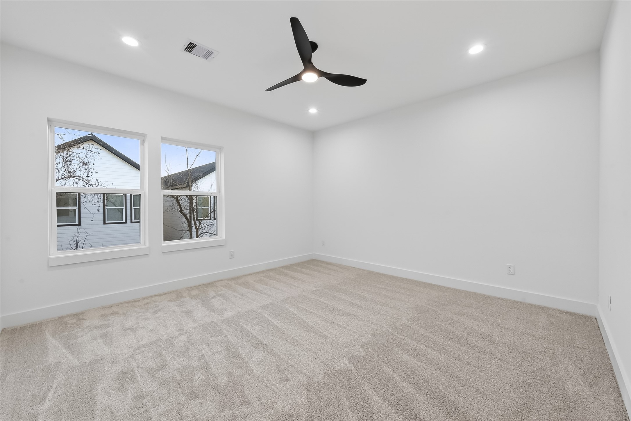 3514 Good Hope Street, Unit B Houston, TX 77021 - Photo 20 of 26 Luxurious master suite featuring spacious design, abundant natural light, and modern ceiling fan for ultimate comfort.