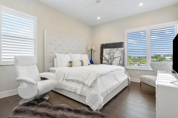a bedroom with a bed and a large window