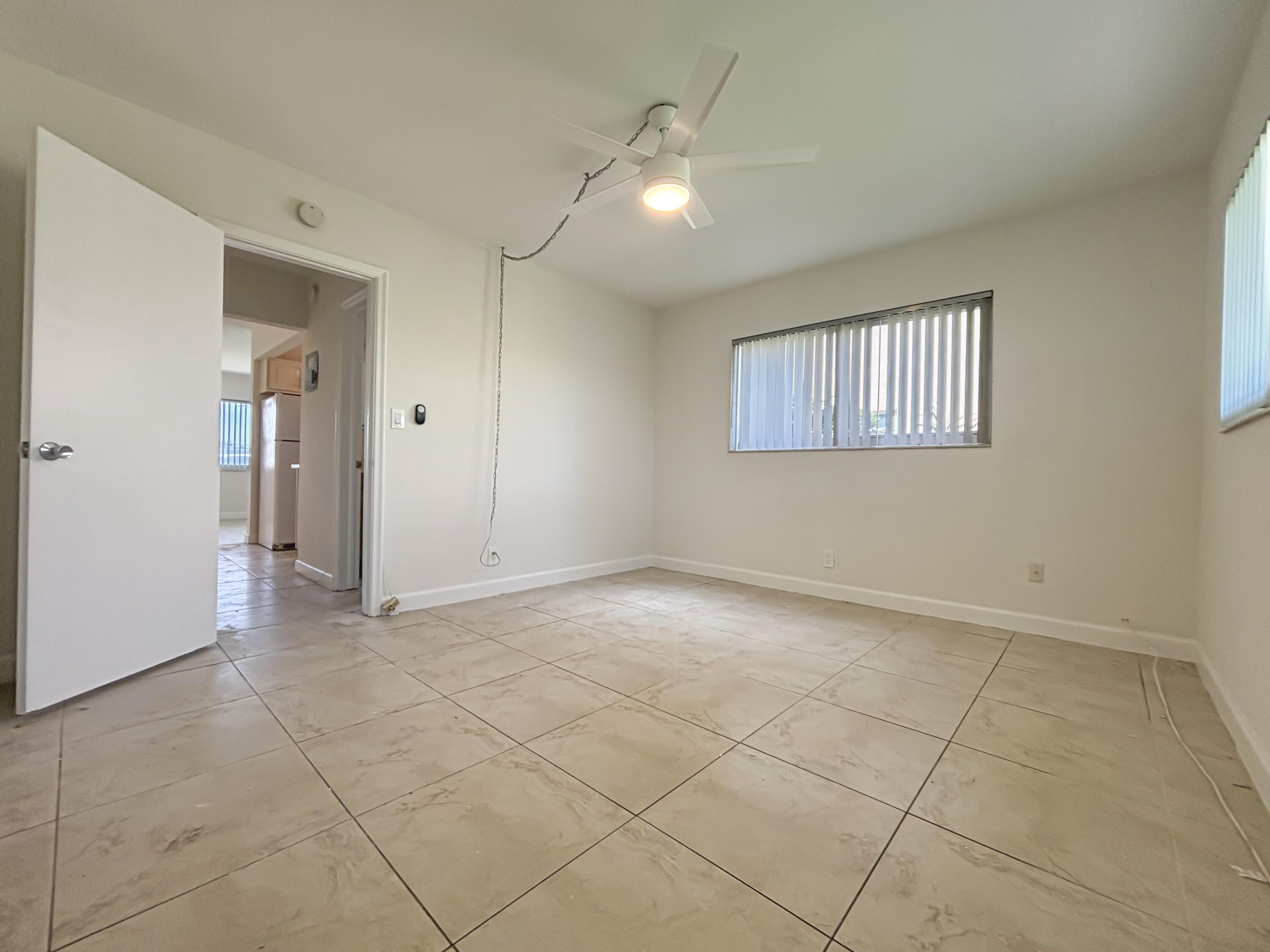 2131 Northeast 40th Court, Unit 1 Lighthouse Point, FL 33064 - Photo 12 of 16 a view of an empty room with a window