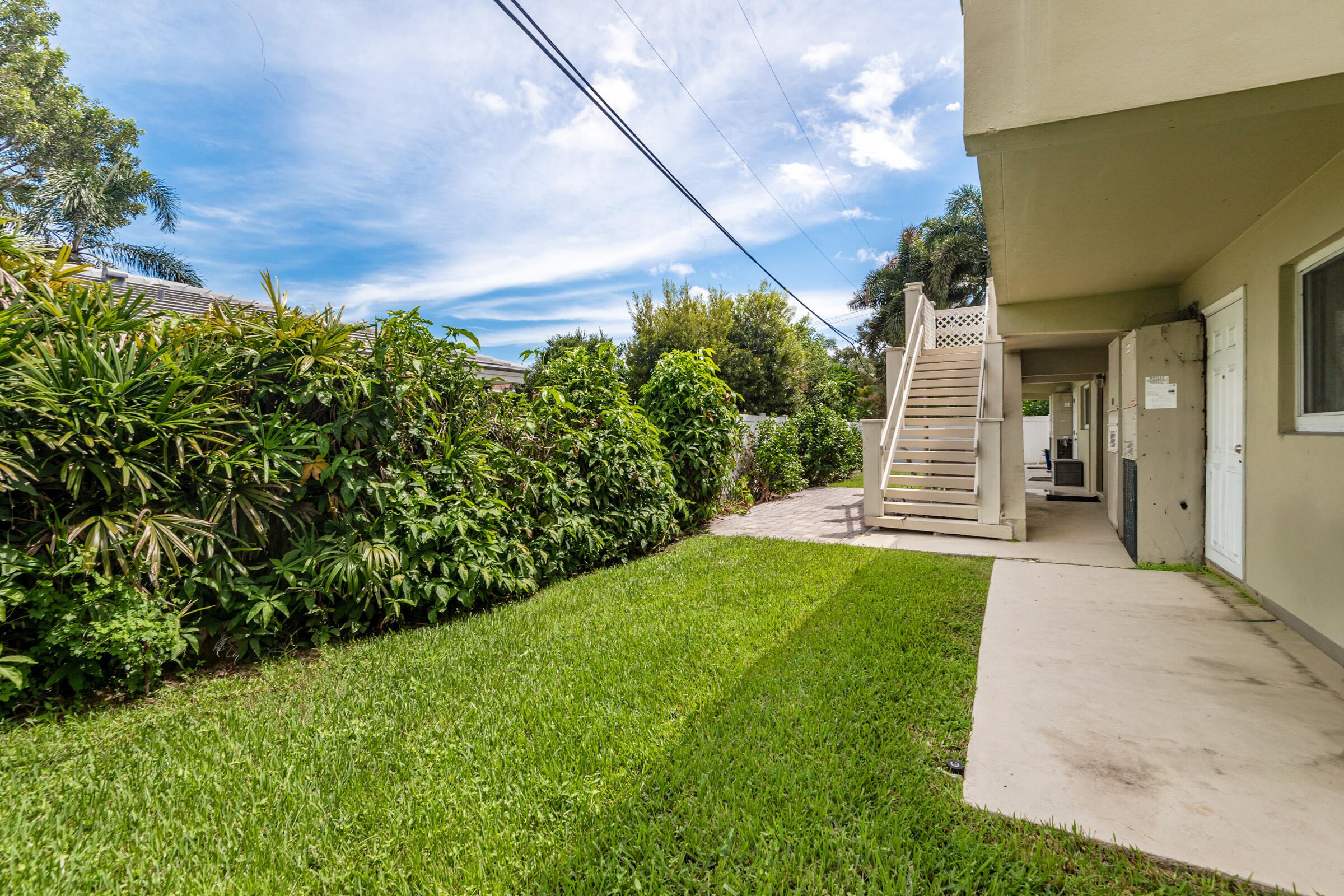 2131 Northeast 40th Court, Unit 1 Lighthouse Point, FL 33064 - Photo 14 of 16 a backyard of a house with lots of green space