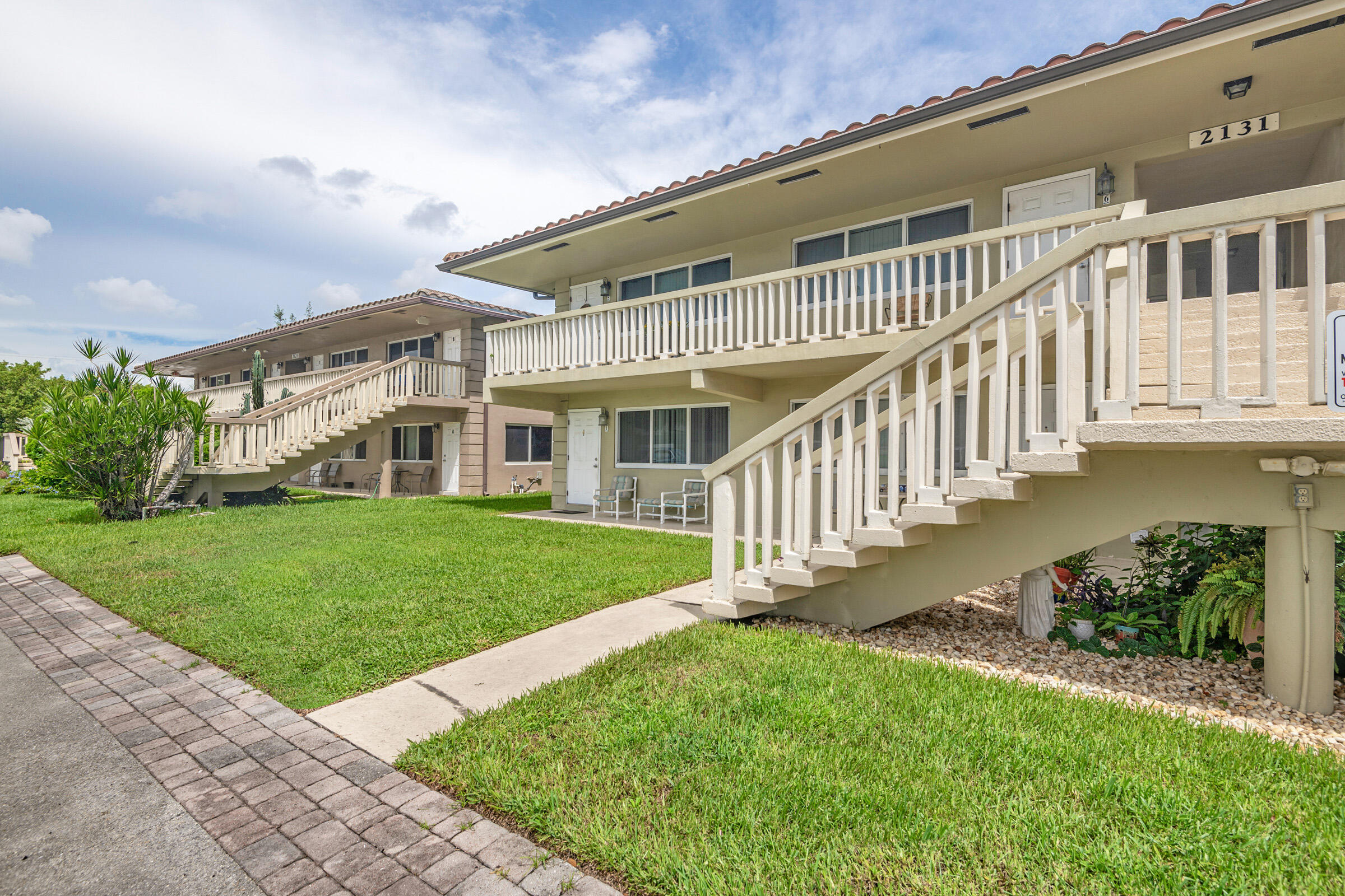 2131 Northeast 40th Court, Unit 1 Lighthouse Point, FL 33064 - Photo 3 of 16 a view of a house with a yard and a garden