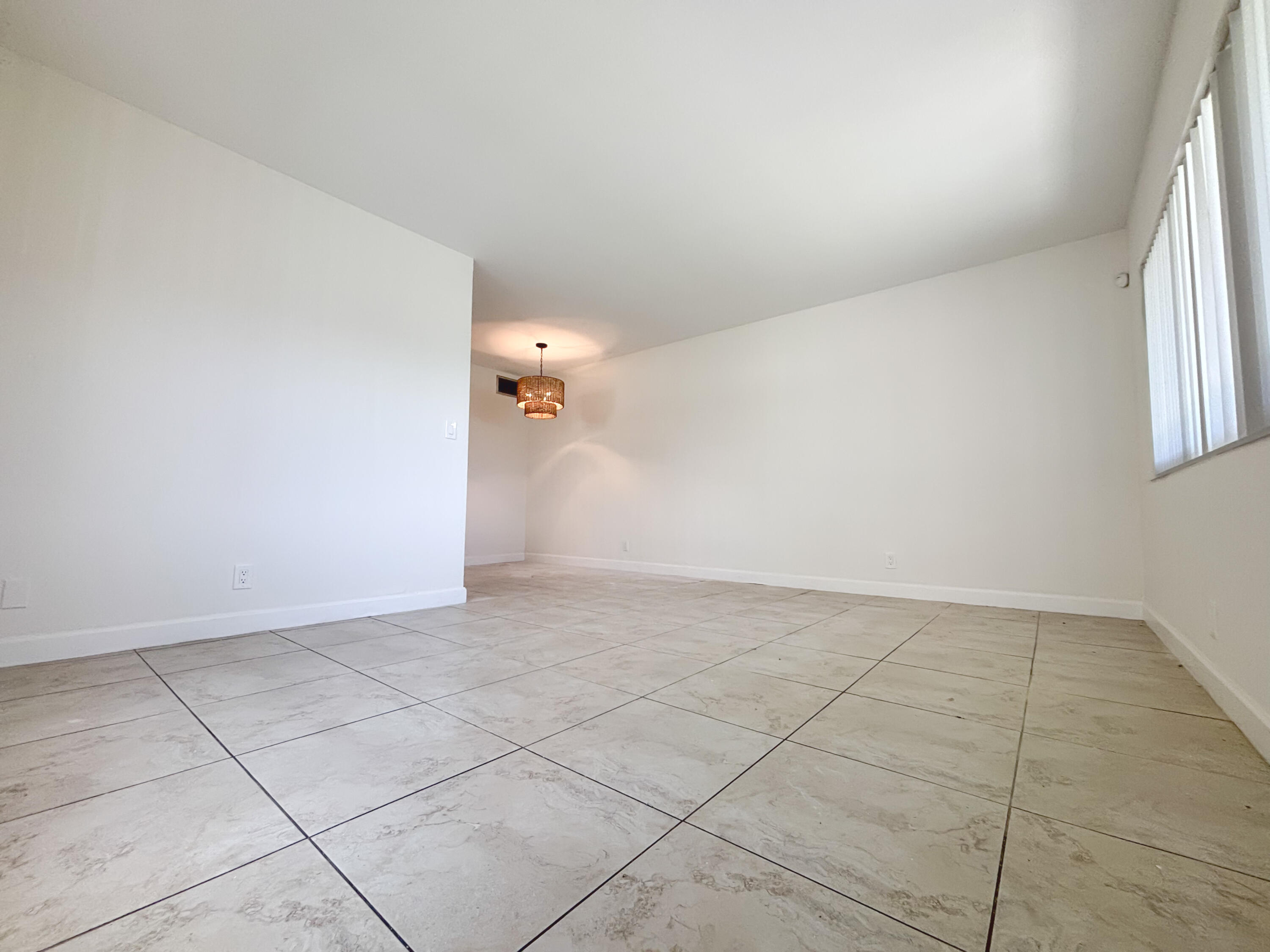 2131 Northeast 40th Court, Unit 1 Lighthouse Point, FL 33064 - Photo 4 of 16 an empty room with windows