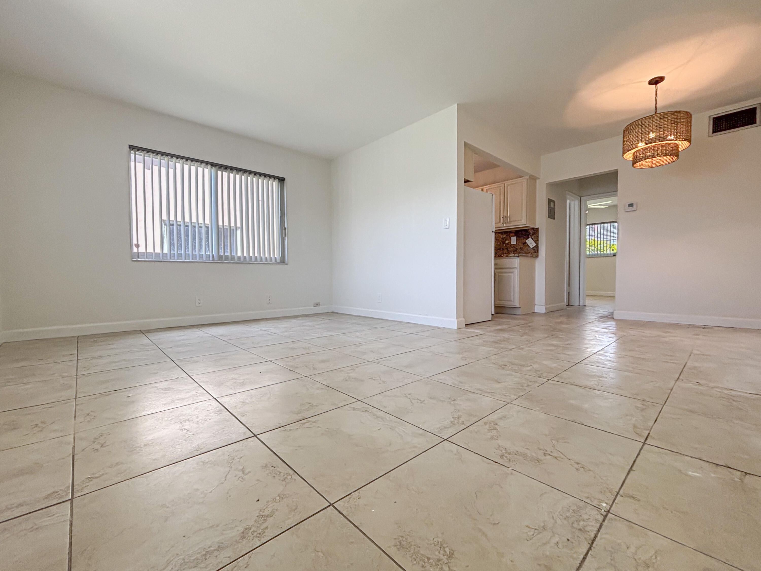 2131 Northeast 40th Court, Unit 1 Lighthouse Point, FL 33064 - Photo 5 of 16 a view of an empty room with a window