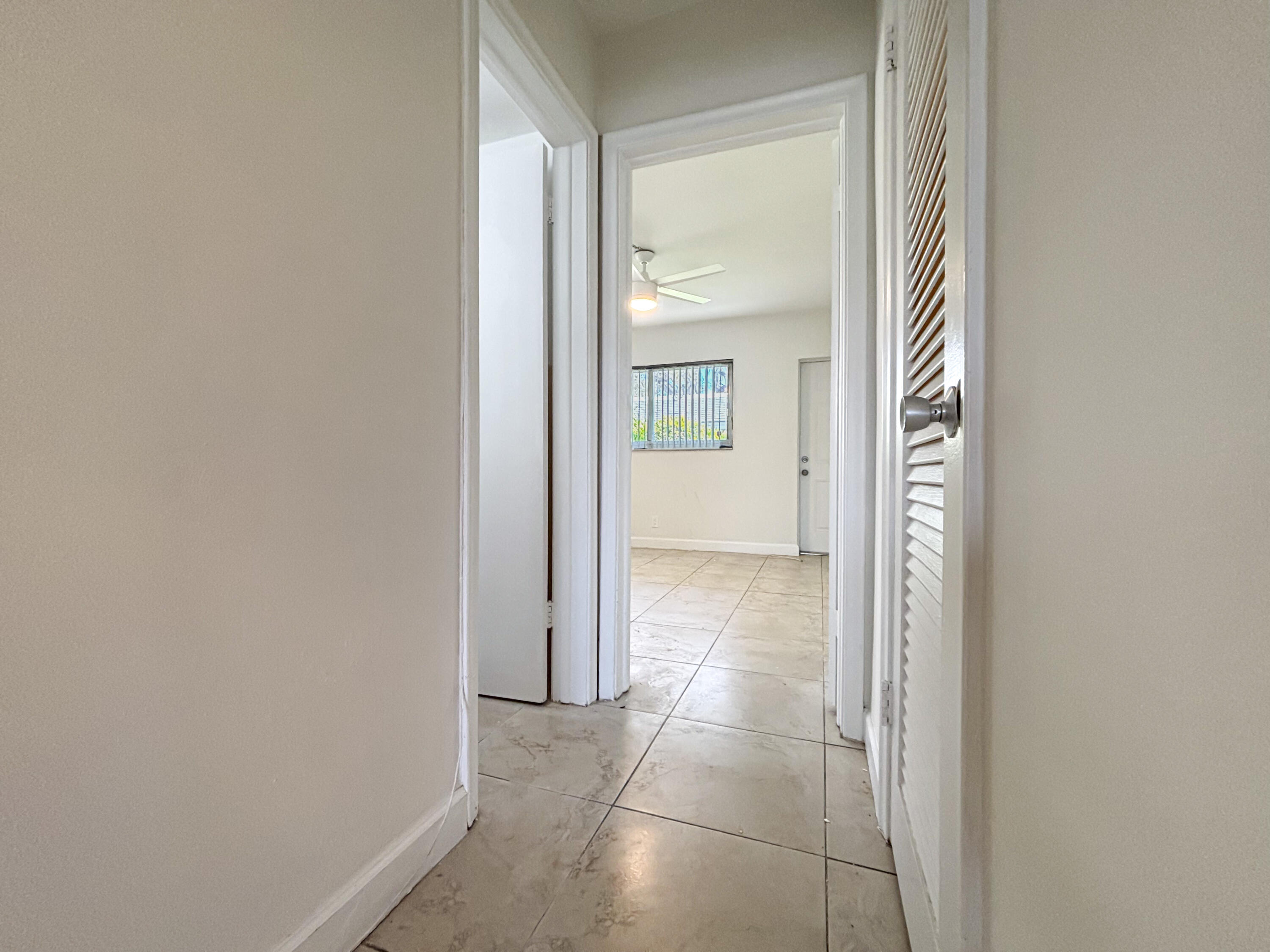 2131 Northeast 40th Court, Unit 1 Lighthouse Point, FL 33064 - Photo 10 of 16 a view of a hallway with wooden floor