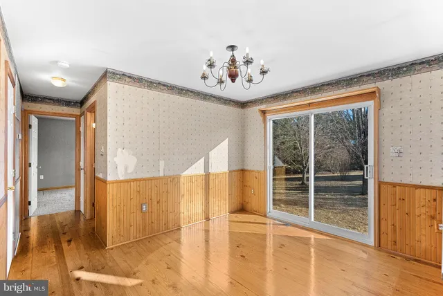 a kitchen with a refrigerator a sink dishwasher and a stove with wooden floor