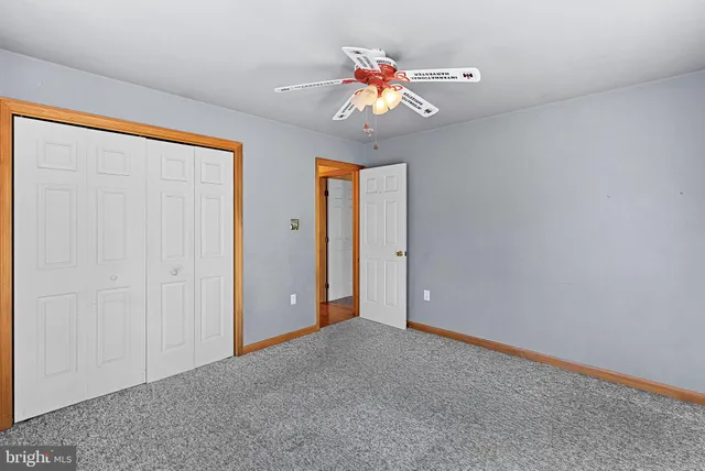 a view of a livingroom with a ceiling fan and window