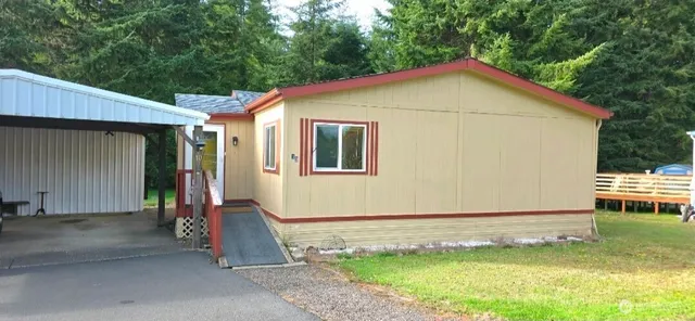 a backyard of a house with barbeque oven