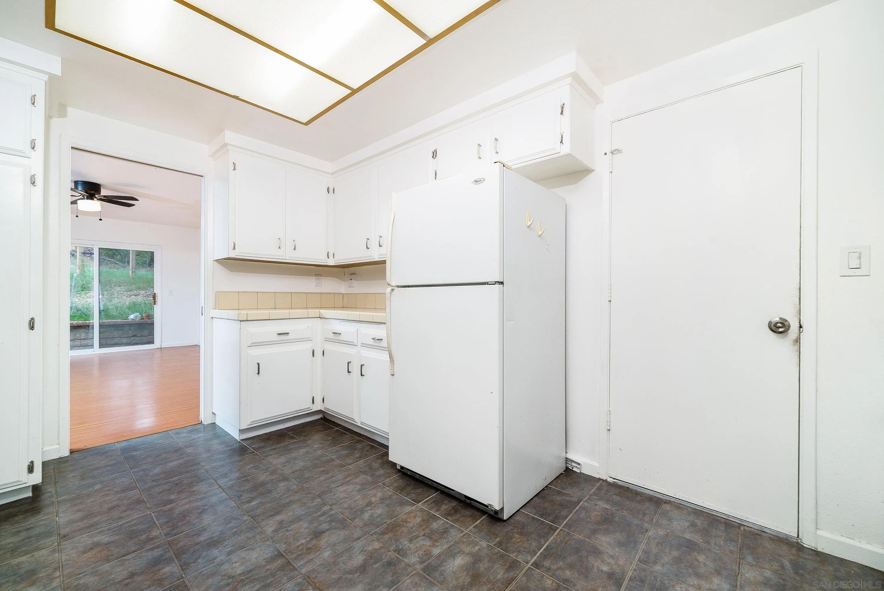 1343 Live Oak Park Road South Fallbrook, CA 92028 - Photo 8 of 55 a kitchen with white cabinets and white appliances