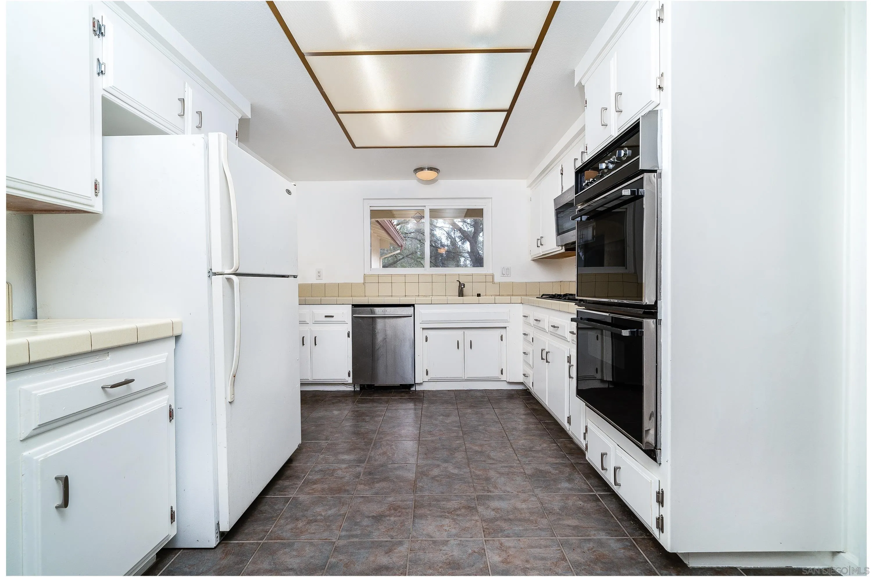 1343 Live Oak Park Road South Fallbrook, CA 92028 - Photo 9 of 55 a kitchen with white cabinets and white appliances