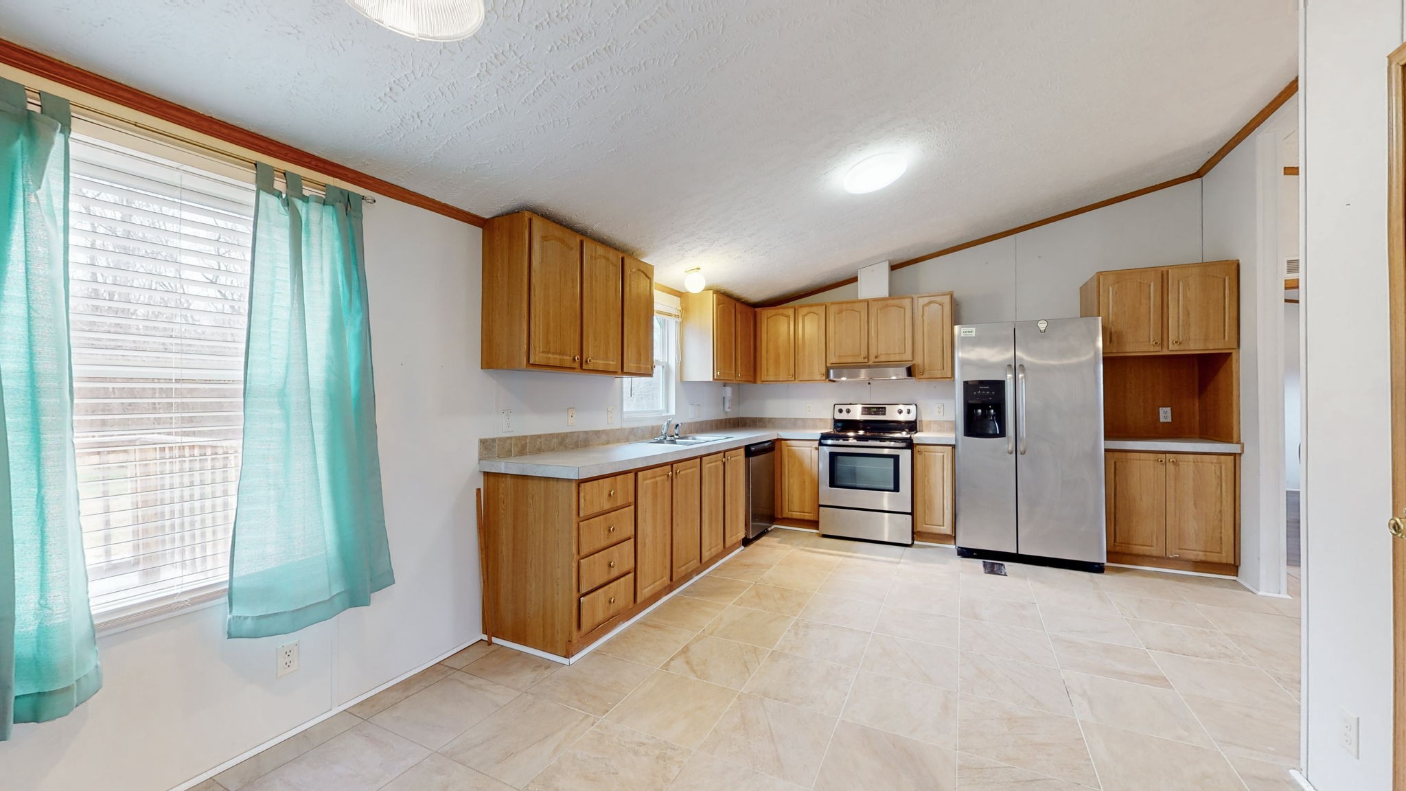 1118 Drake Road Clarksville, TN 37043 - Photo 14 of 38 a kitchen with granite countertop a refrigerator and a stove top oven