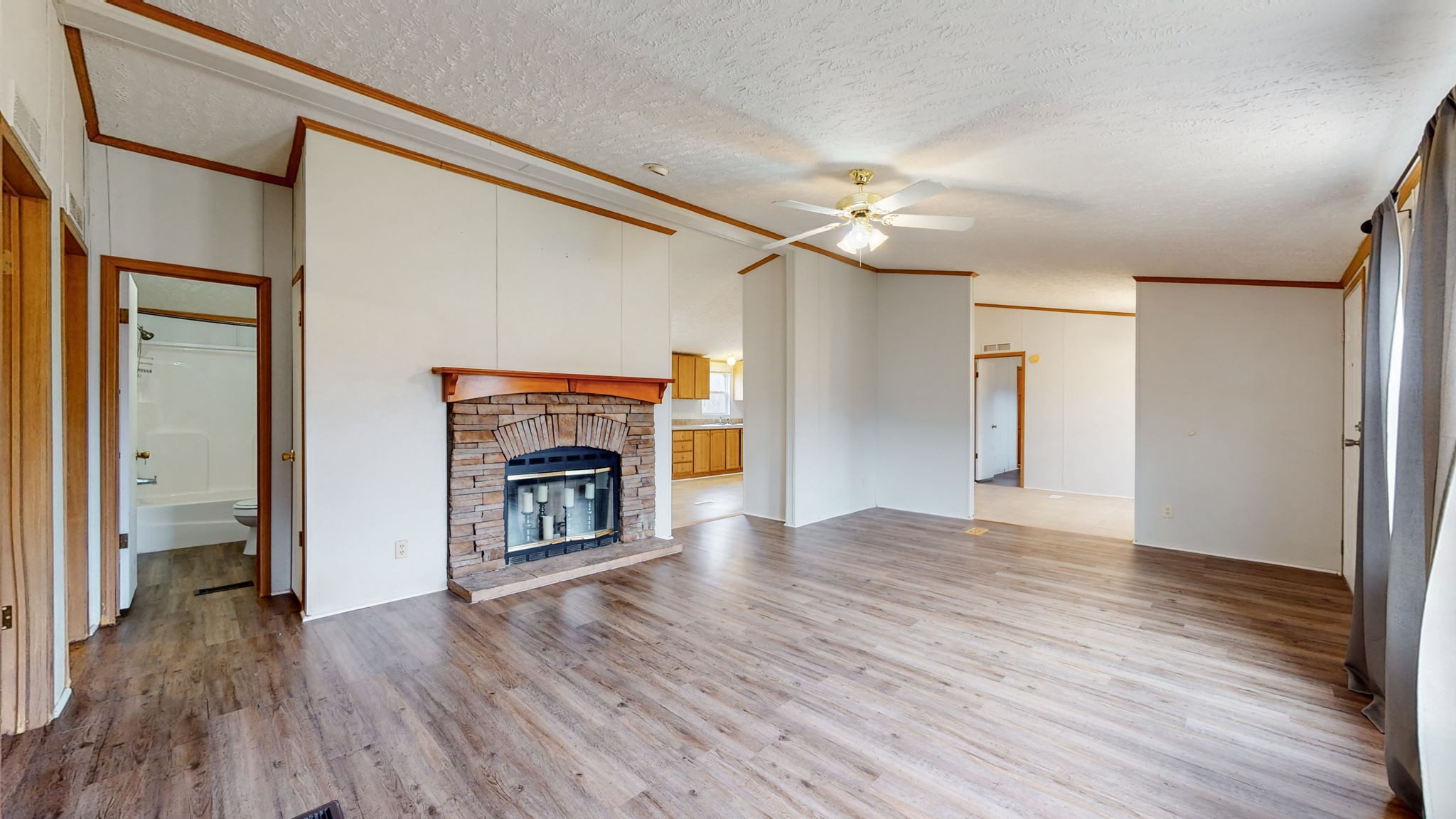1118 Drake Road Clarksville, TN 37043 - Photo 2 of 38 a view of an empty room with wooden floor fireplace and a window