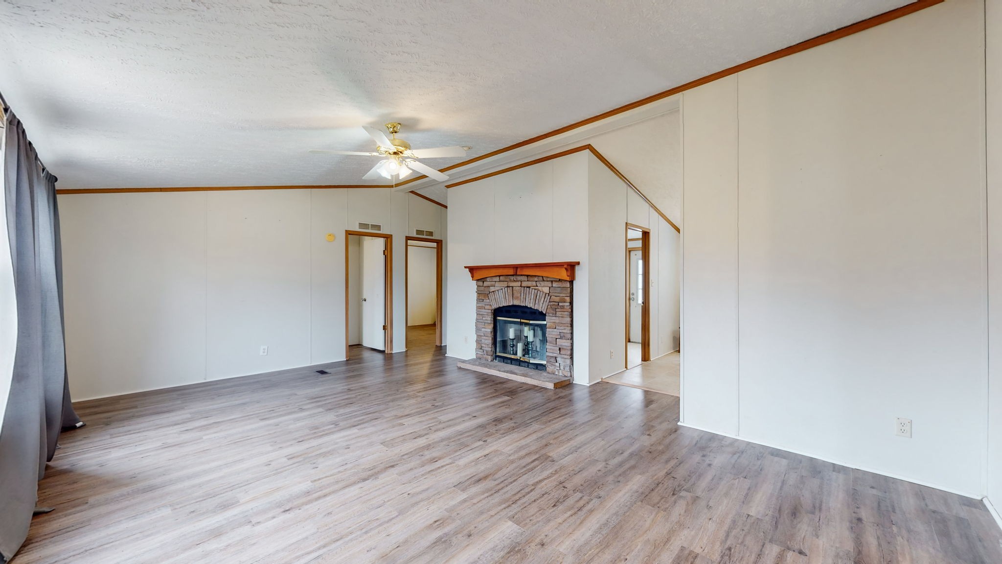 1118 Drake Road Clarksville, TN 37043 - Photo 3 of 38 a view of an empty room with wooden floor fireplace and a window